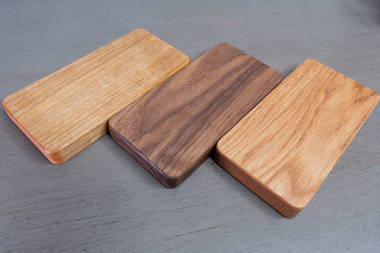 All 3 variants of Glasses Tray, Birch on the left, Walnut in the middle, and Oak on the right.